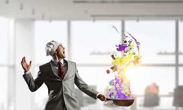 Handsome businessman in cook hat with pan in hands. Mixed media making money with catering and events