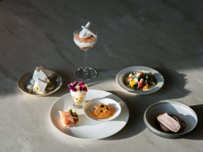 Five small tasting portions arranged on a table at an elegant fine-dining setting.